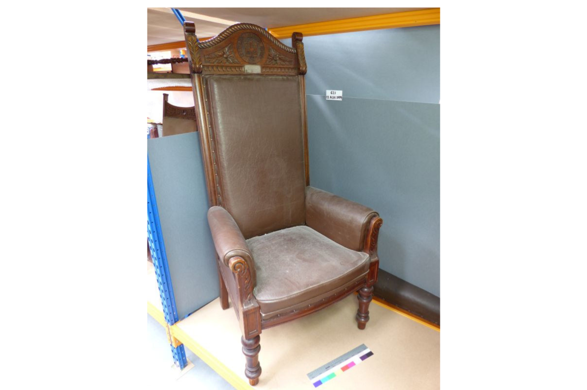 High-backed chair with carved wooden frame
