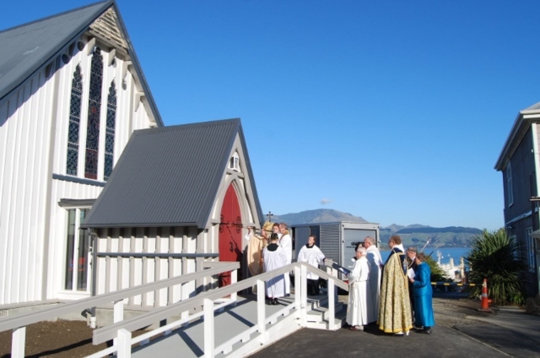 Bishop Victoria Matthews strikes the door of St. Saviours at Holy Trinity as part of the consecration ceremony, 7th June 2015.